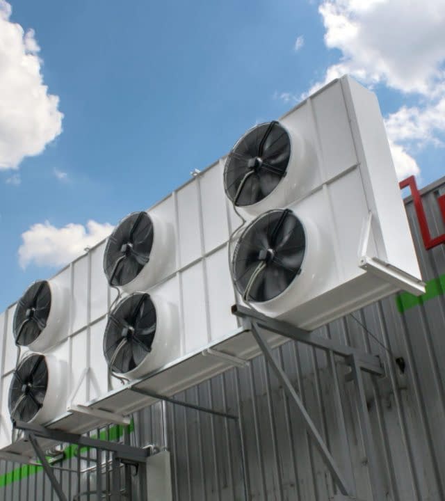 Air conditioning system assembled on side of a building.